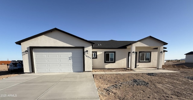 36269 W Highland Ave, Phoenix, AZ 85033 - ranch-style home with concrete driveway, stucco siding, an attached garage, and a shingled roof