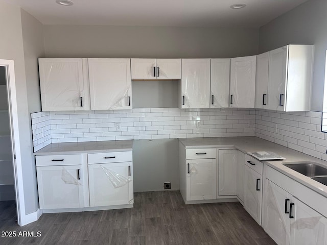 36269 W Highland Ave, Phoenix, AZ 85033 - kitchen with white cabinetry, dark wood-type flooring, tasteful backsplash, recessed lighting, and light countertops