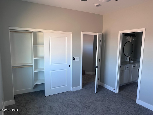 36269 W Highland Ave, Phoenix, AZ 85033 - unfurnished bedroom featuring dark colored carpet, baseboards, connected bathroom, and a closet