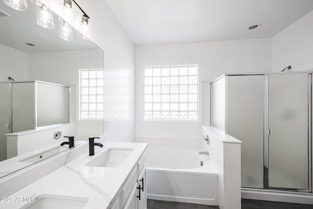 bathroom featuring vanity and shower with separate bathtub