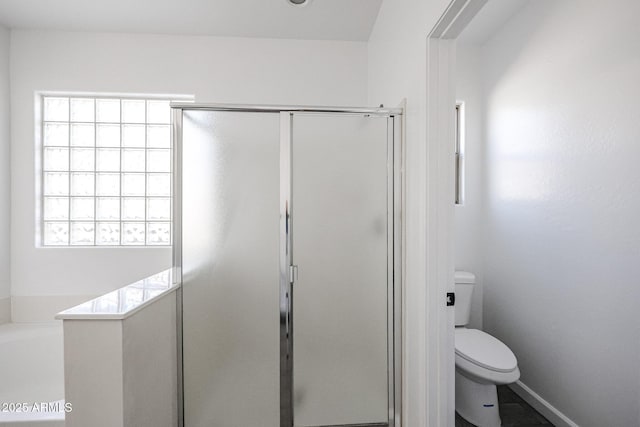 bathroom featuring separate shower and tub and toilet