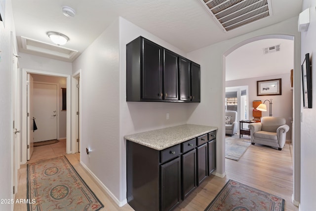 corridor with light hardwood / wood-style flooring