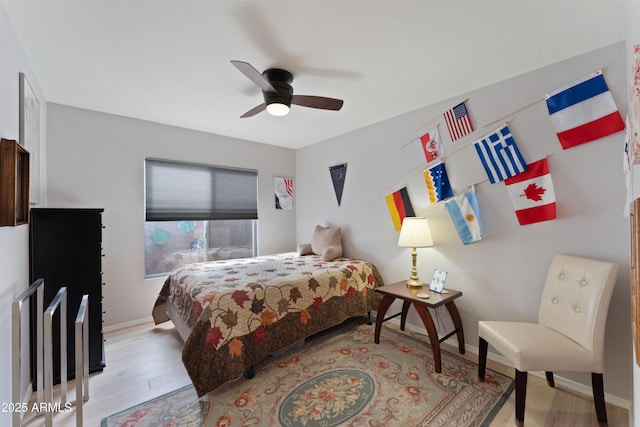 bedroom with light hardwood / wood-style flooring and ceiling fan