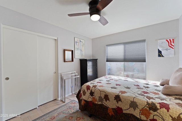 bedroom with ceiling fan, light hardwood / wood-style floors, and a closet