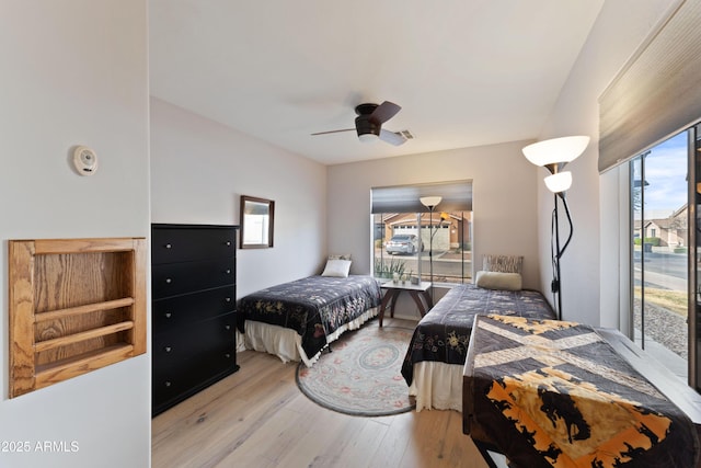 bedroom with access to exterior, ceiling fan, and light hardwood / wood-style flooring