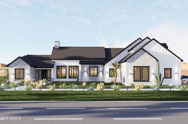 modern inspired farmhouse with a front lawn