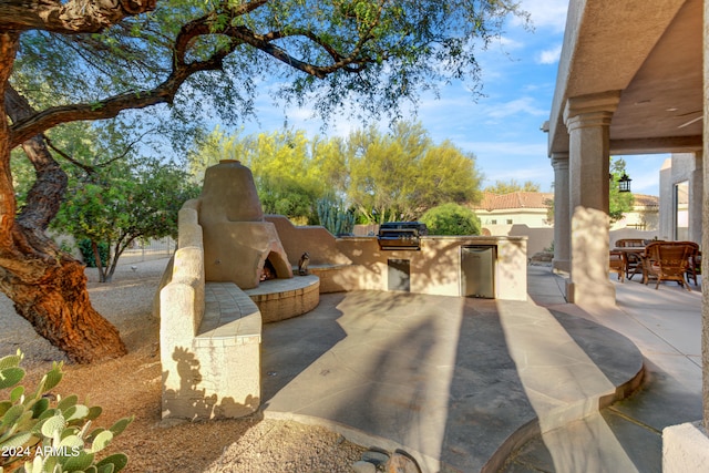 view of patio / terrace with area for grilling and a grill