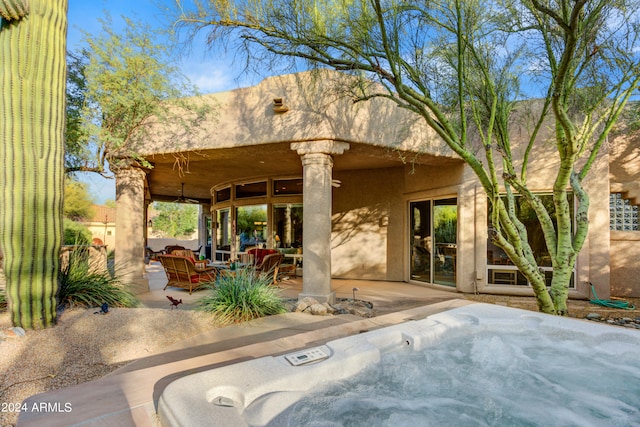 view of patio / terrace with a hot tub and ceiling fan