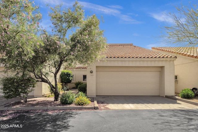 7101 W Beardsley Rd Unit 1502, Glendale, AZ 85308 - mediterranean / spanish-style home with stucco siding, a garage, a tile roof, and driveway