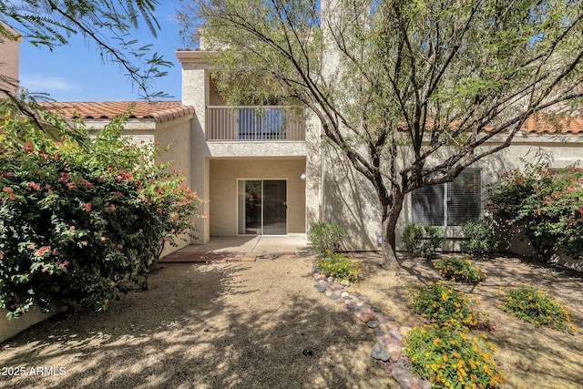 7101 W Beardsley Rd Unit 1502, Glendale, AZ 85308 - back of property featuring a balcony, stucco siding, a tiled roof, and a patio