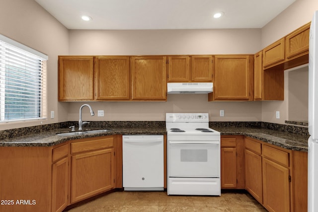 7101 W Beardsley Rd Unit 1502, Glendale, AZ 85308 - kitchen featuring white appliances, under cabinet range hood, a sink, dark stone countertops, and brown cabinetry