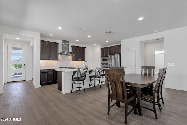 dining area with sink and light hardwood / wood-style flooring