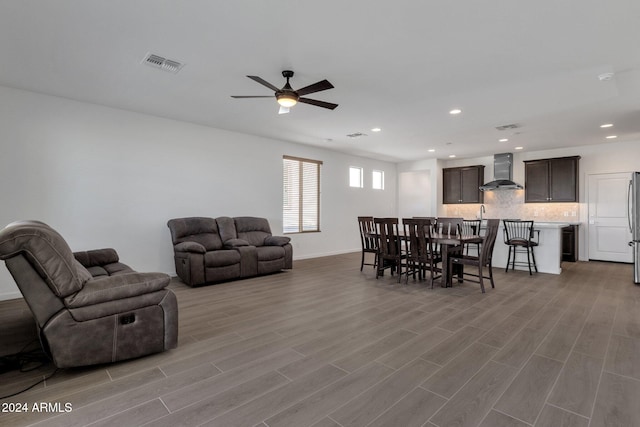 living room with ceiling fan and light wood-type flooring