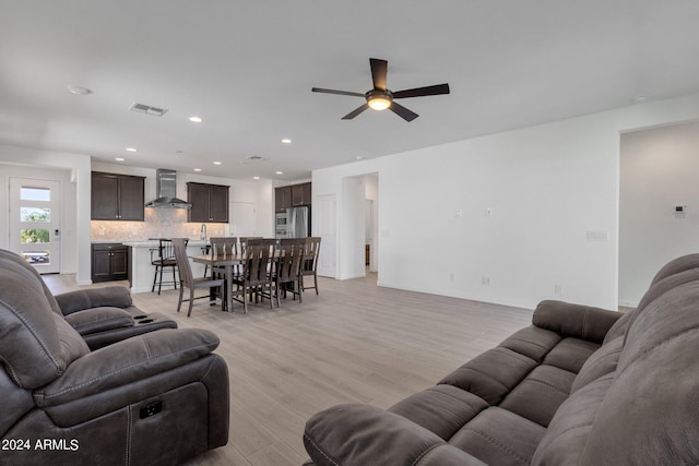 living room featuring ceiling fan and light wood-type flooring