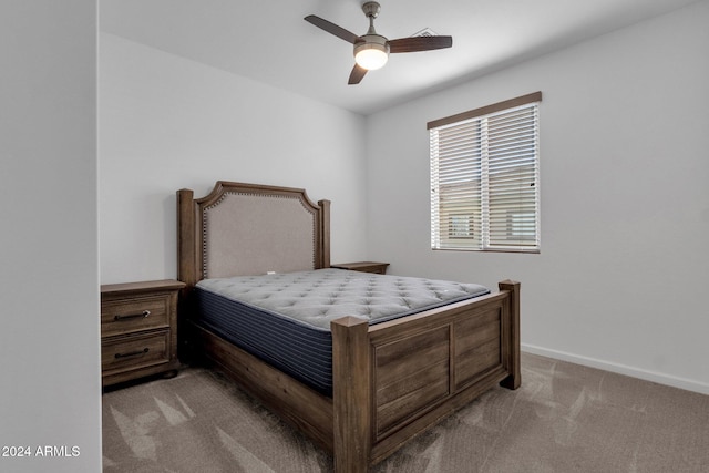 bedroom featuring light carpet and ceiling fan