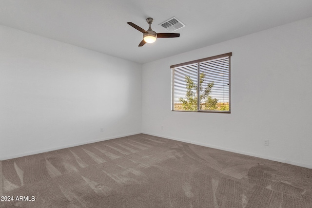 spare room featuring ceiling fan and carpet