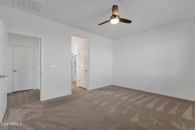 empty room featuring light carpet and ceiling fan