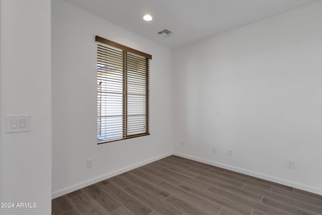 spare room with dark hardwood / wood-style flooring