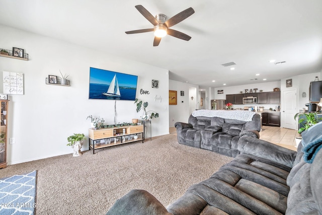 carpeted living room with ceiling fan