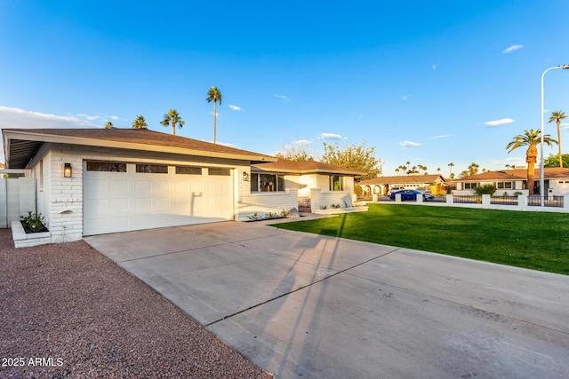 single story home featuring a garage and a front yard