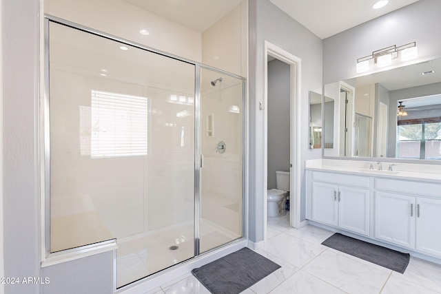 bathroom with vanity, toilet, walk in shower, and ceiling fan