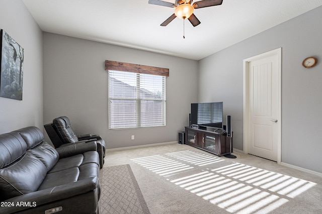 carpeted living room with ceiling fan