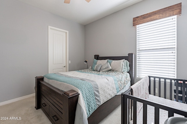 bedroom featuring light carpet and ceiling fan