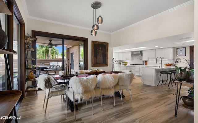 4450 E Camelback Rd Unit 4, Phoenix, AZ 85018 - dining space featuring crown molding and light wood finished floors