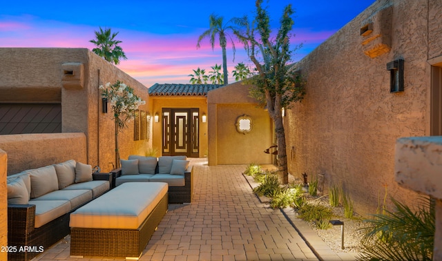 4450 E Camelback Rd Unit 4, Phoenix, AZ 85018 - patio terrace at dusk with outdoor lounge area