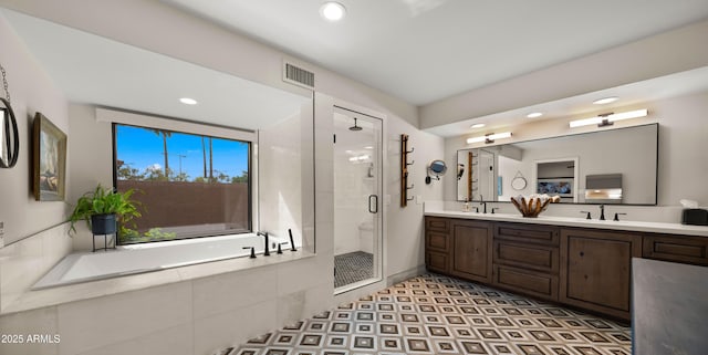4450 E Camelback Rd Unit 4, Phoenix, AZ 85018 - bathroom featuring a sink, recessed lighting, a shower stall, visible vents, and a bath