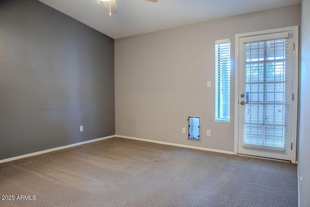 empty room with ceiling fan and carpet flooring