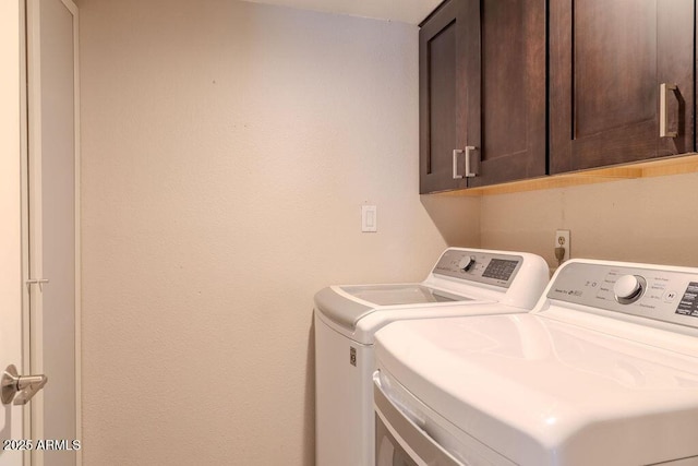 laundry area featuring cabinets and washer and dryer