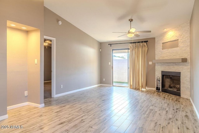 unfurnished living room with ceiling fan, a fireplace, and light wood-type flooring