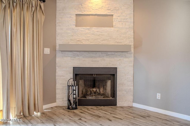 room details featuring hardwood / wood-style flooring and a fireplace