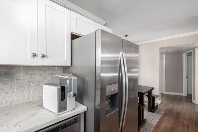 kitchen with white cabinetry, crown molding, appliances with stainless steel finishes, and tasteful backsplash