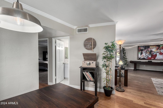 corridor featuring crown molding and hardwood / wood-style floors