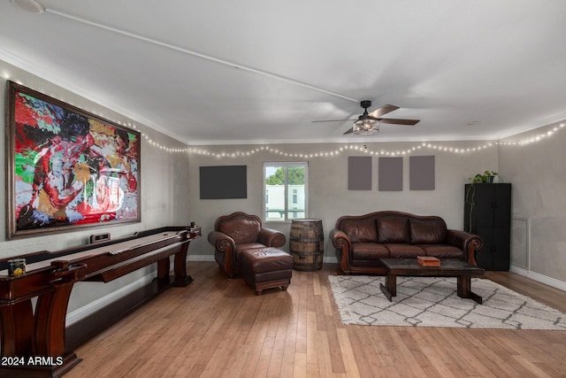 living room with light hardwood / wood-style flooring, ceiling fan, and ornamental molding