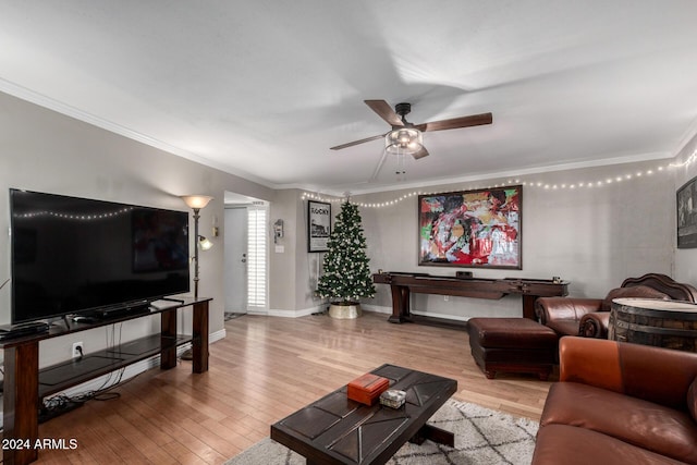 living room featuring hardwood / wood-style flooring, ceiling fan, and crown molding