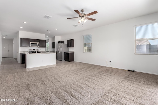 28259 N Chalcocite St, San Tan Valley, AZ 85143 - kitchen with stainless steel appliances, open floor plan, ceiling fan, light colored carpet, and a center island with sink