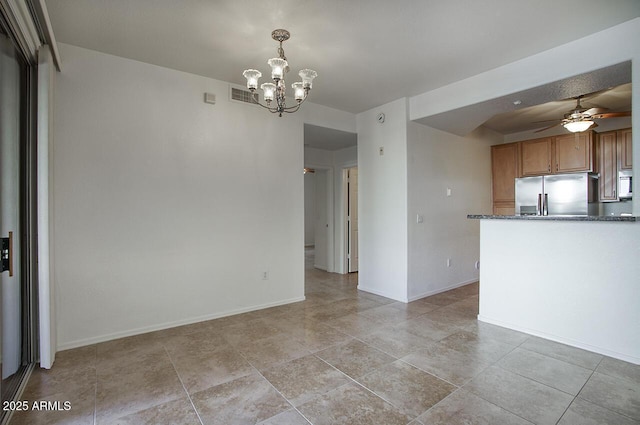 kitchen with visible vents, appliances with stainless steel finishes, brown cabinetry, baseboards, and ceiling fan with notable chandelier