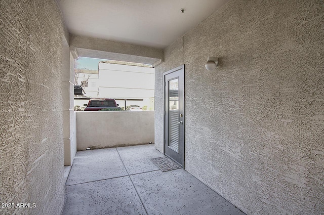 property entrance with stucco siding