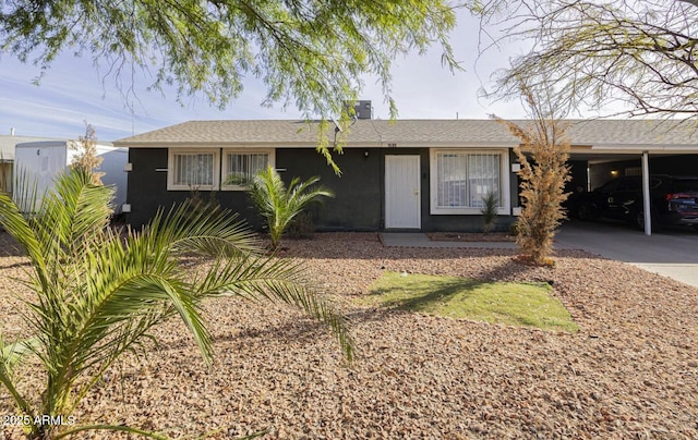 single story home featuring a carport and driveway