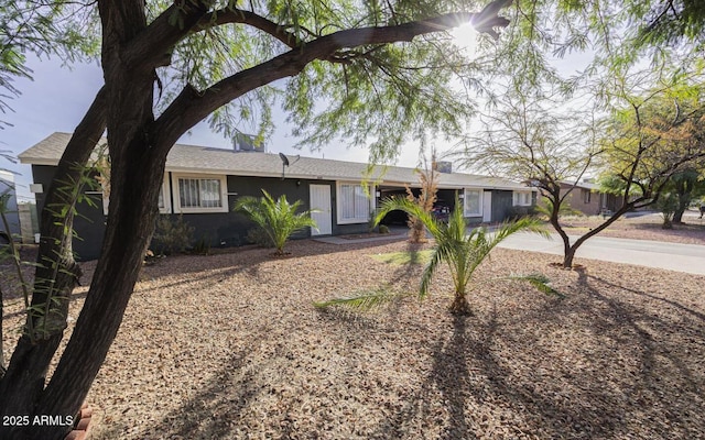 single story home with stucco siding and driveway