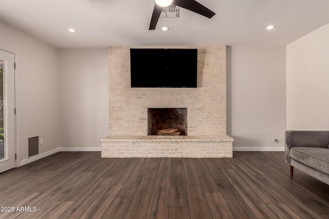 unfurnished living room with a brick fireplace, a ceiling fan, baseboards, recessed lighting, and wood finished floors