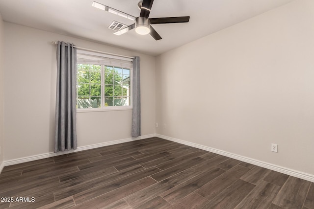 unfurnished room with a ceiling fan, baseboards, visible vents, and dark wood-style floors
