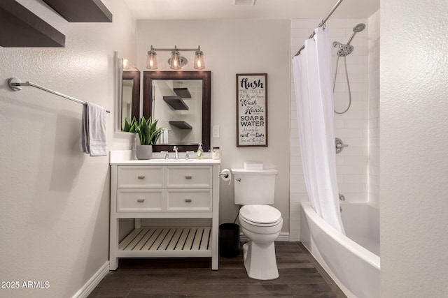 bathroom featuring shower / bath combo, vanity, toilet, baseboards, and wood finished floors