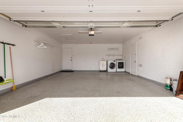 garage featuring separate washer and dryer, baseboards, and a garage door opener