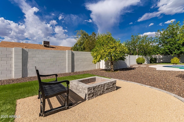 view of patio / terrace with a fenced backyard, a fenced in pool, and a fire pit