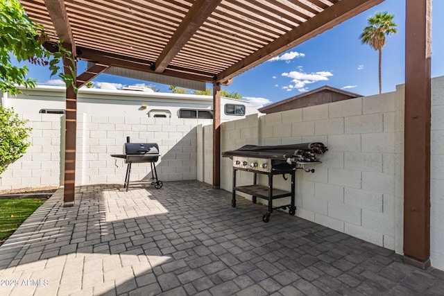view of patio / terrace with fence, a pergola, and a grill