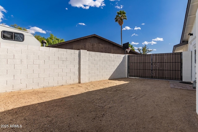 view of yard with fence and a gate